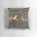 Decorative throw pillow featuring a magical unicorn and deer among a lush, floral forest scene.