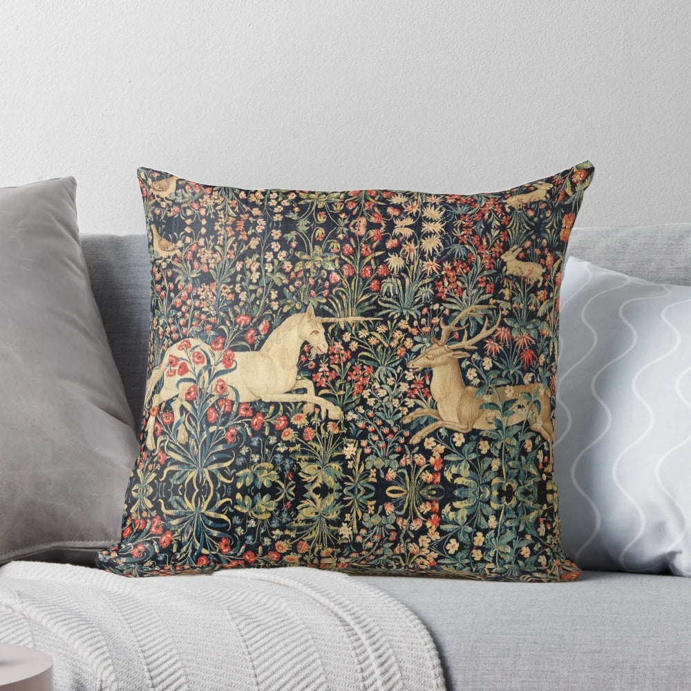 Decorative throw pillow featuring a magical unicorn and deer among a lush, floral forest scene.