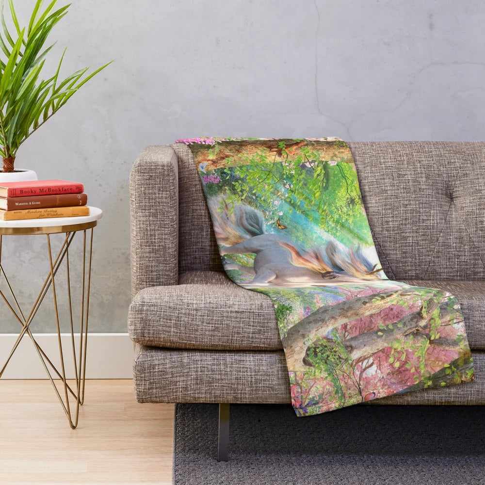 Enchanting unicorn-themed plush blanket featuring a fantasy forest scene with butterflies and rainbows