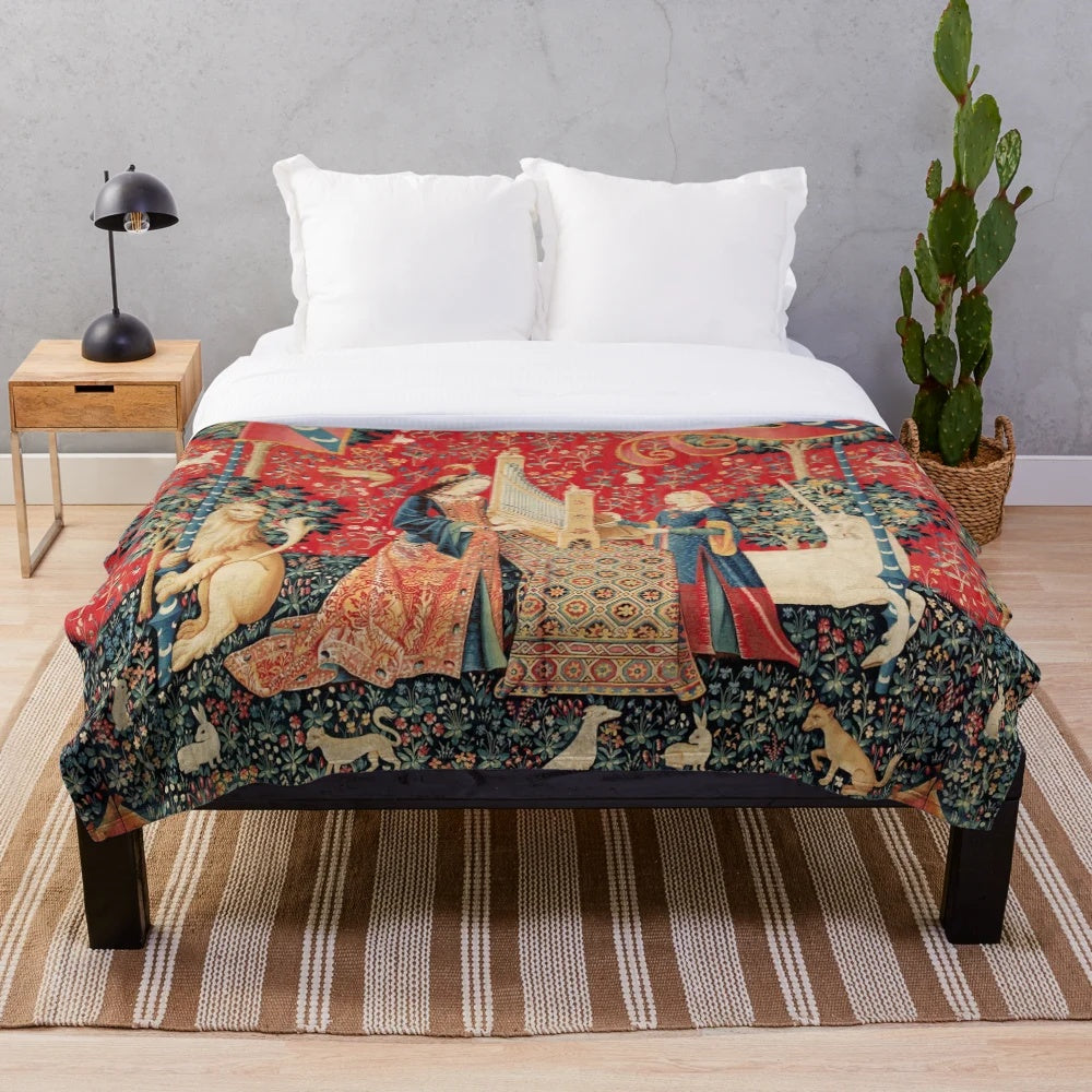 Artistic plush blanket featuring a unicorn and lady playing an organ surrounded by fantastical animals and floral elements