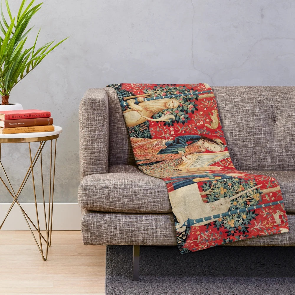 Artistic plush blanket featuring a unicorn and lady playing an organ surrounded by fantastical animals and floral elements