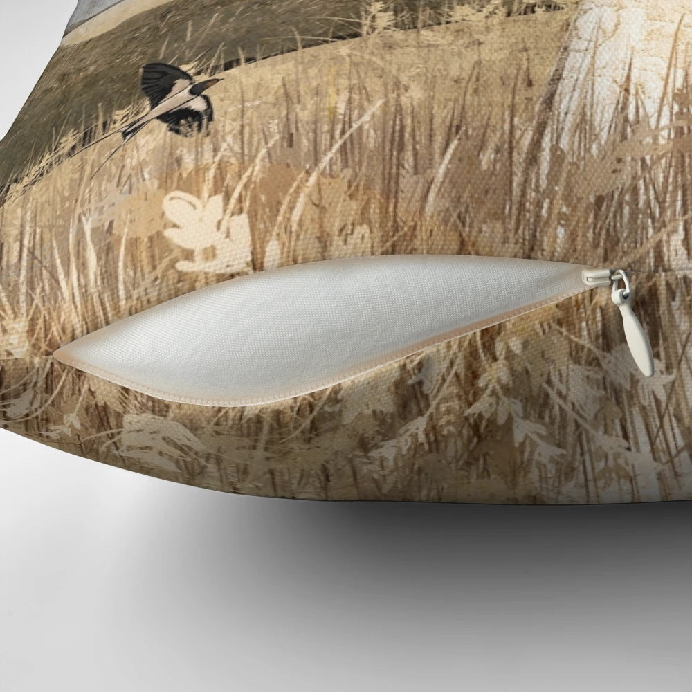 A cozy pillow featuring a whimsical scene of swallows flying over a wheat field, with a touch of ghostly elements.