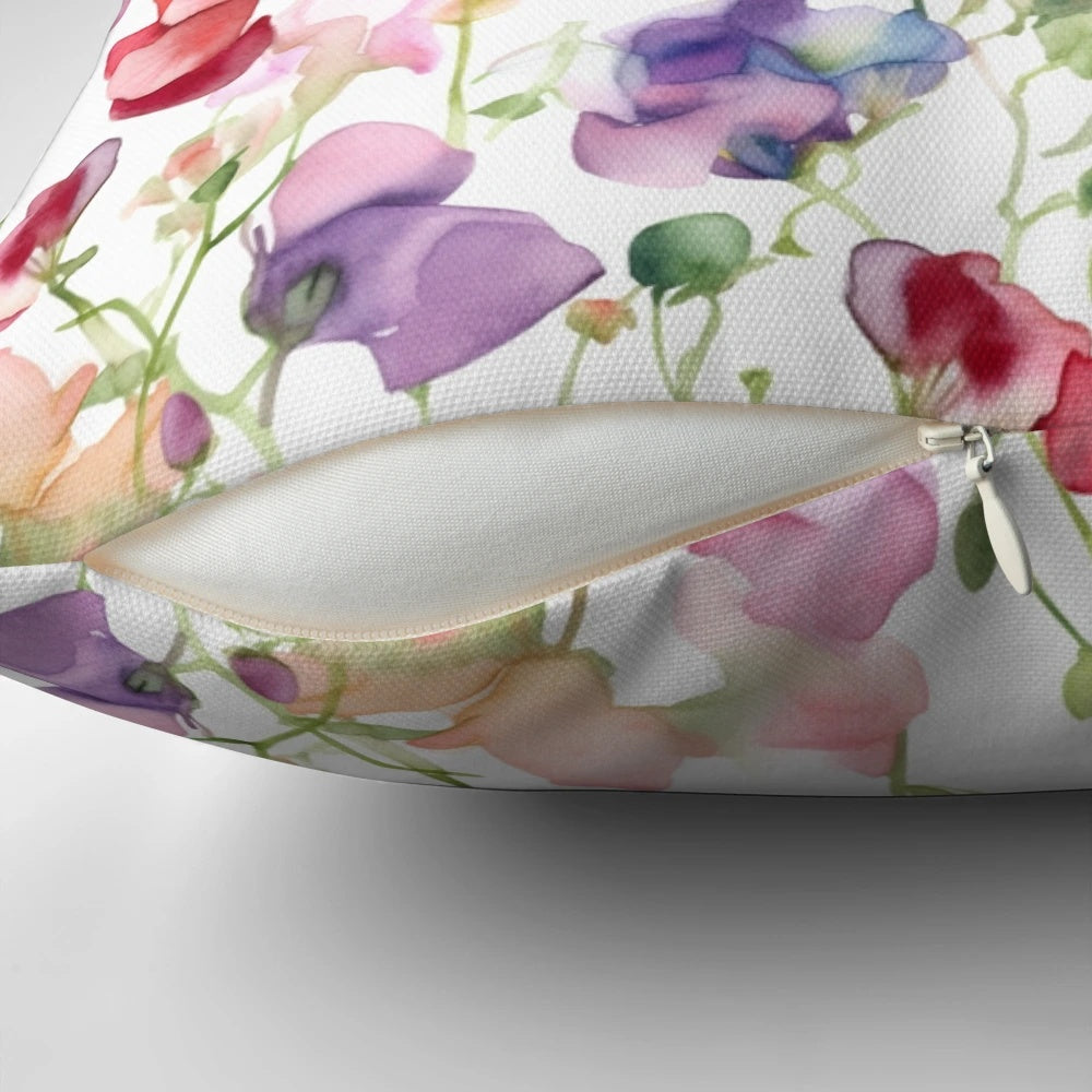 A decorative throw pillow featuring a beautiful watercolor painting of sweet pea flowers.