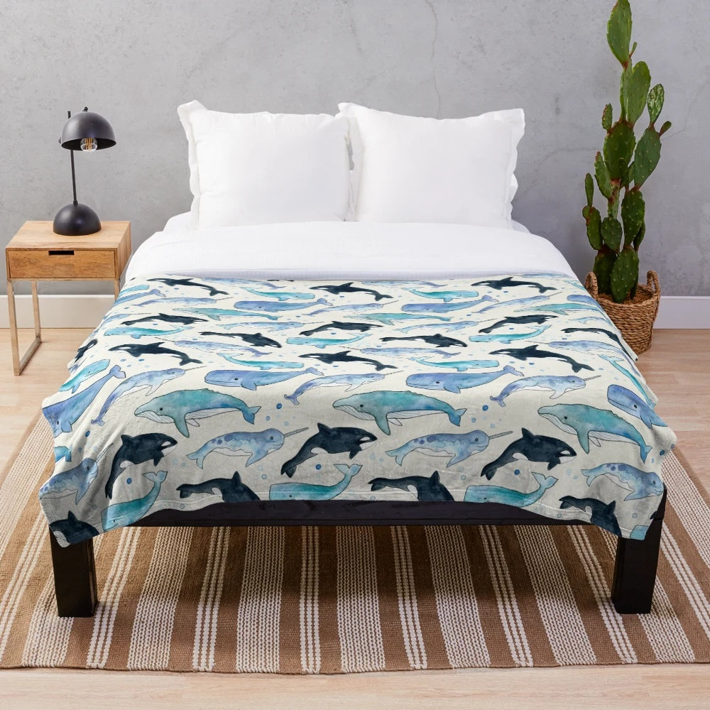 Watercolor design featuring whales, orcas, and narwhals