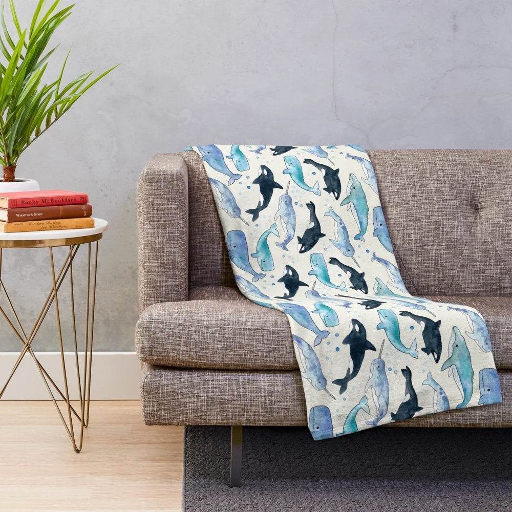 Watercolor design featuring whales, orcas, and narwhals