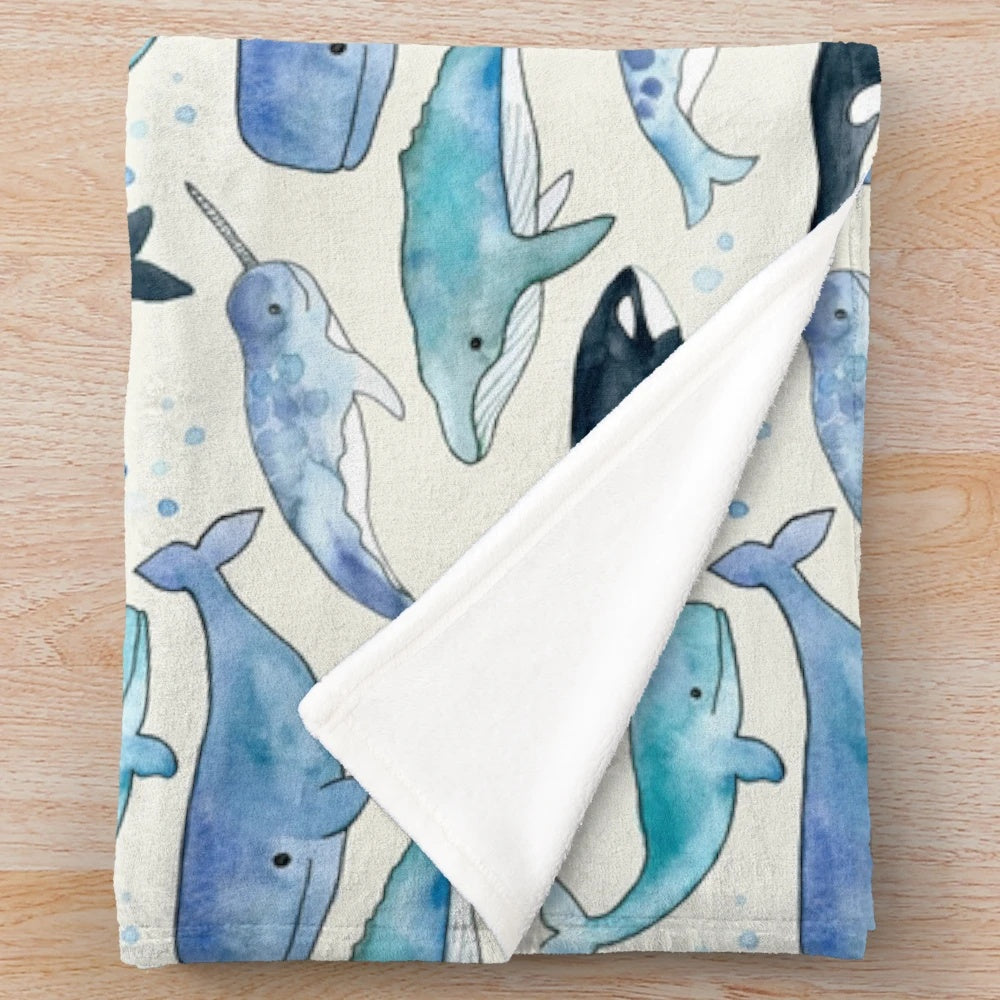 Watercolor design featuring whales, orcas, and narwhals