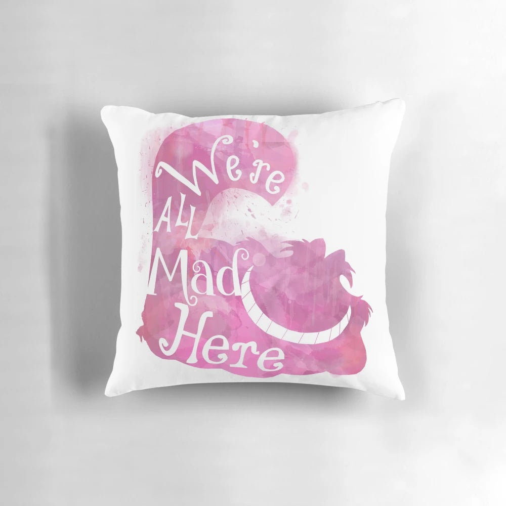 Colorful throw pillow featuring the iconic Cheshire Cat quote "We're All Mad Here" from Alice in Wonderland
