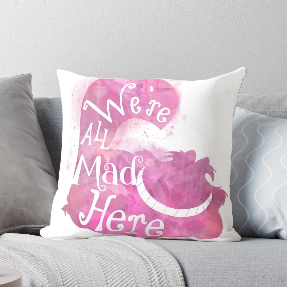 Colorful throw pillow featuring the iconic Cheshire Cat quote "We're All Mad Here" from Alice in Wonderland