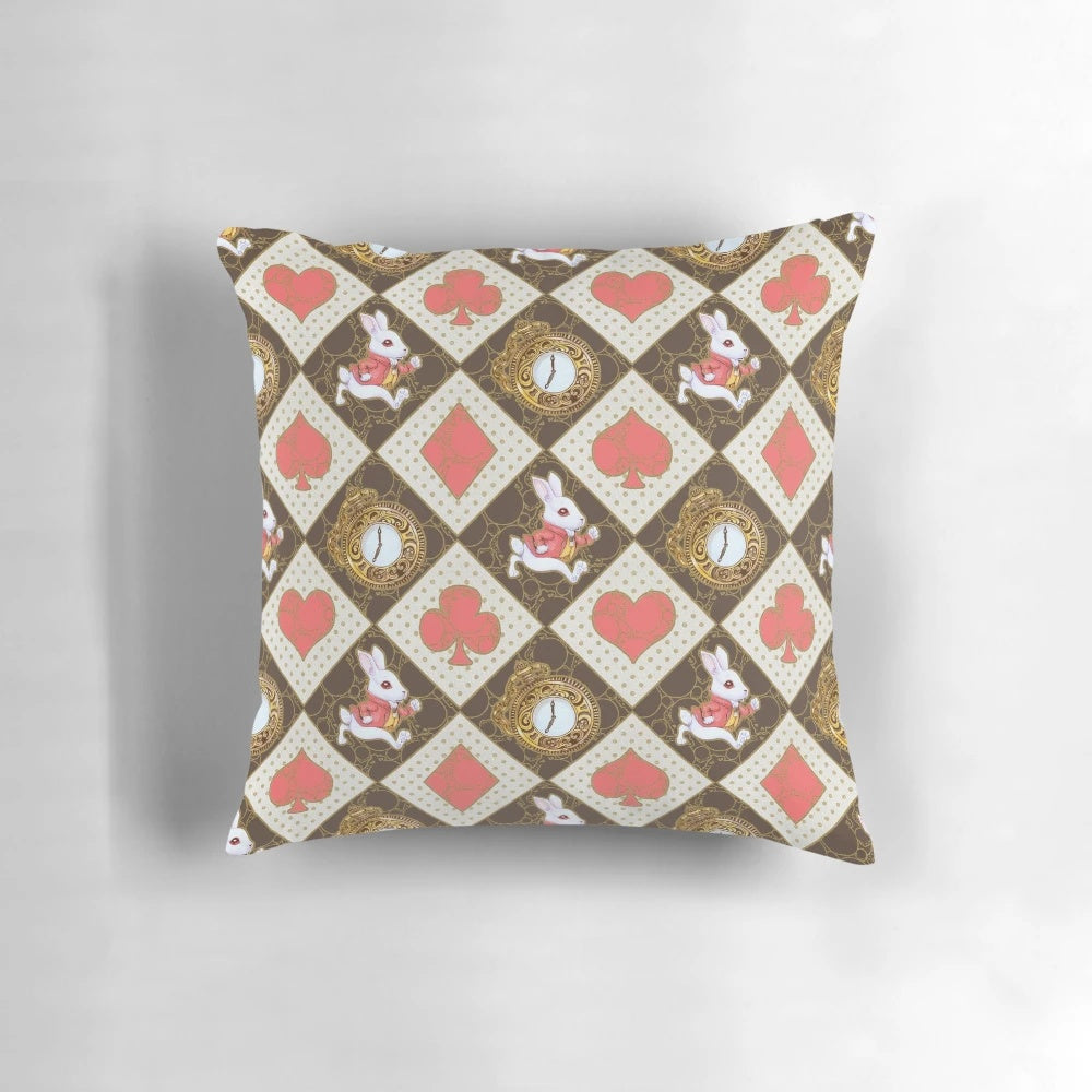 A soft, white rabbit-themed pillow with a whimsical, watercolor-style pattern of hearts, spades, and a pocket watch.
