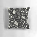 Decorative pillow featuring a witchcraft design in black and white