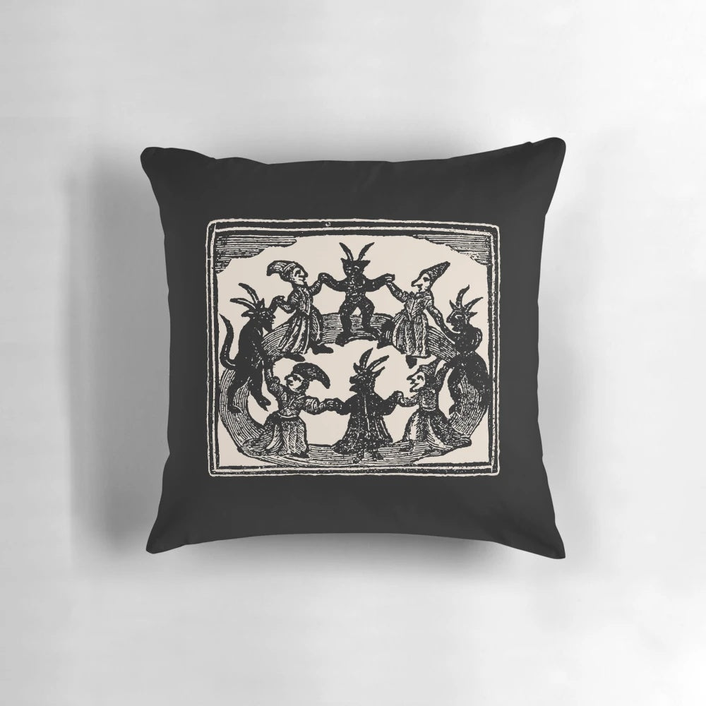 Decorative pillow featuring a woodcut-style illustration of witches dancing in a circle, perfect for Wiccan or pagan rituals and decor.
