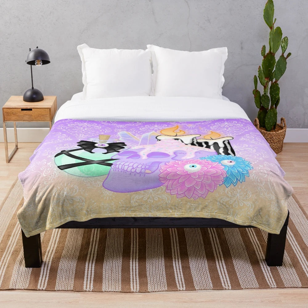 Cozy plush blanket with witch's essentials and spooky design