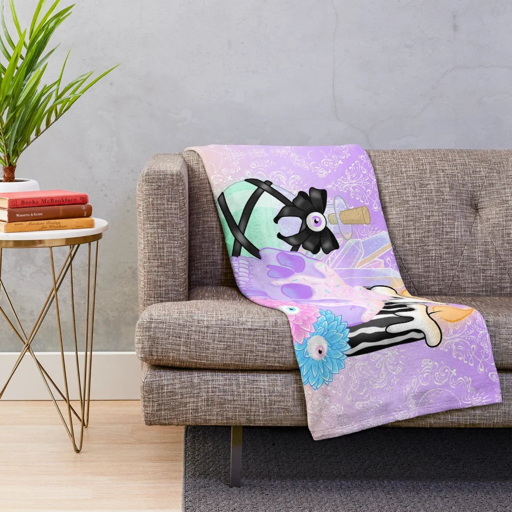 Cozy plush blanket with witch's essentials and spooky design