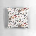Closeup of a decorative throw pillow featuring various woodland animals like bears, foxes, and deer in a forest scene.