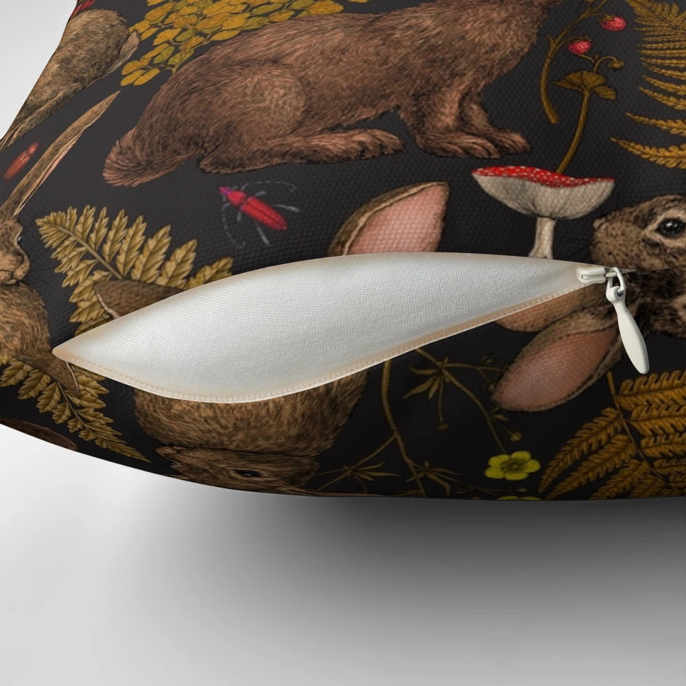 Pillow featuring a whimsical design of rabbits, ferns, and other woodland flora