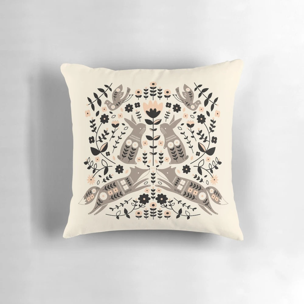 Decorative pillow featuring a whimsical forest-themed folk art design with foxes, rabbits, and birds.