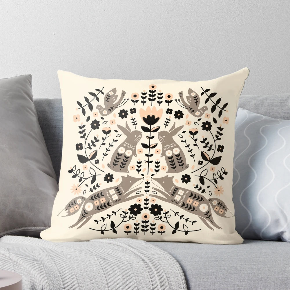 Decorative pillow featuring a whimsical forest-themed folk art design with foxes, rabbits, and birds.