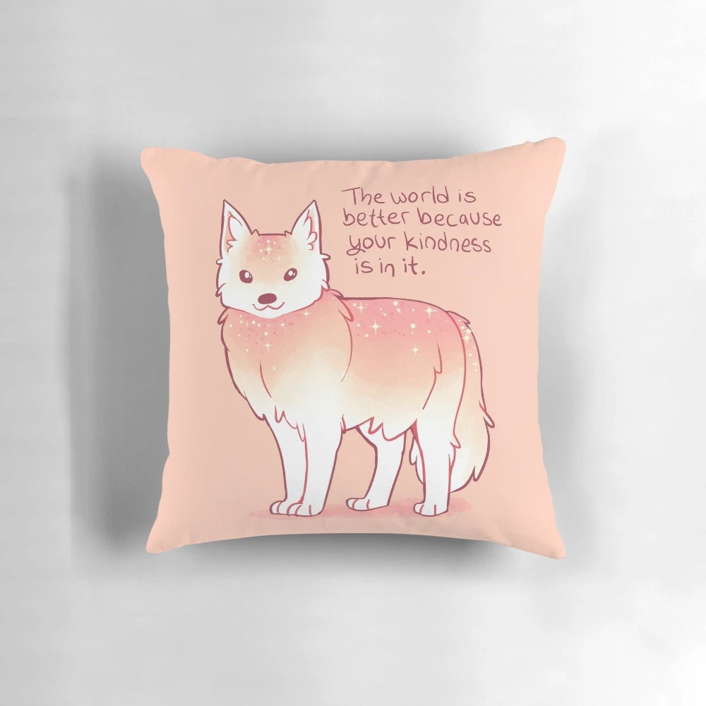 A soft, pastel-colored wolf pillow with the text "The World is Better Because Your Kindness is in it.