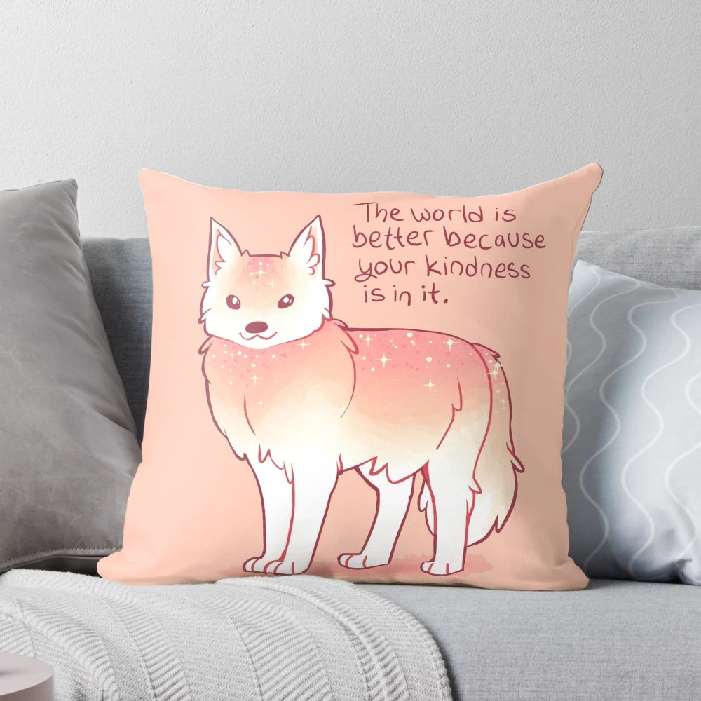 A soft, pastel-colored wolf pillow with the text "The World is Better Because Your Kindness is in it.