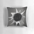 Monochromatic pillow featuring a surreal, abstract floral design with a focus on contrast and minimalist form.