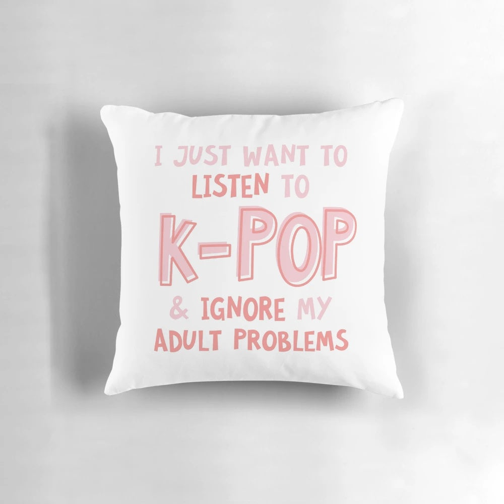 A black and white pillow with the text "I just want to listen to kpop and forget about my adult problems" in a typographic design.