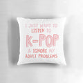 A black and white pillow with the text "I just want to listen to kpop and forget about my adult problems" in a typographic design.