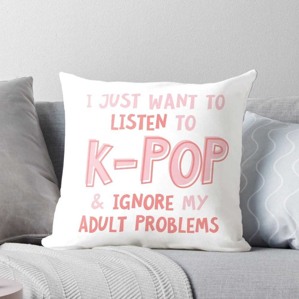 A black and white pillow with the text "I just want to listen to kpop and forget about my adult problems" in a typographic design.