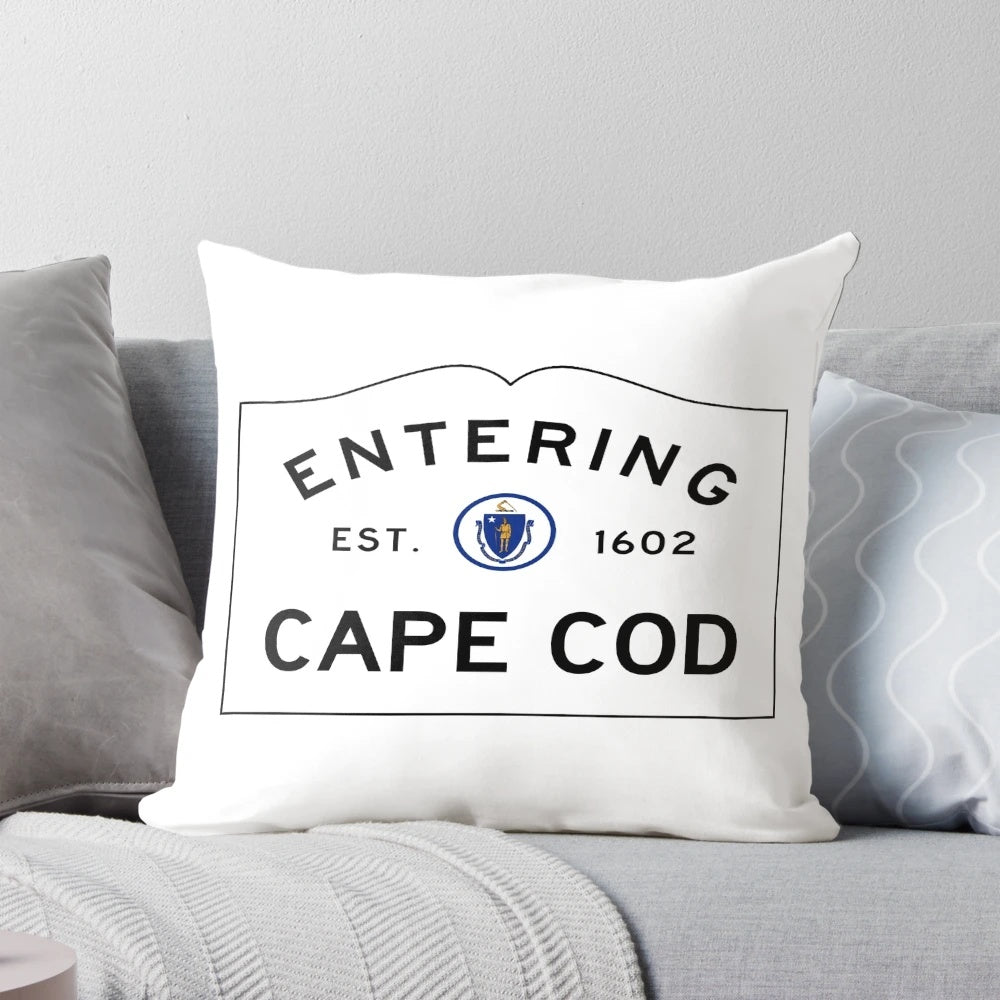 Throw pillow featuring a road sign for "Entering Cape Cod" in a coastal Massachusetts landscape.