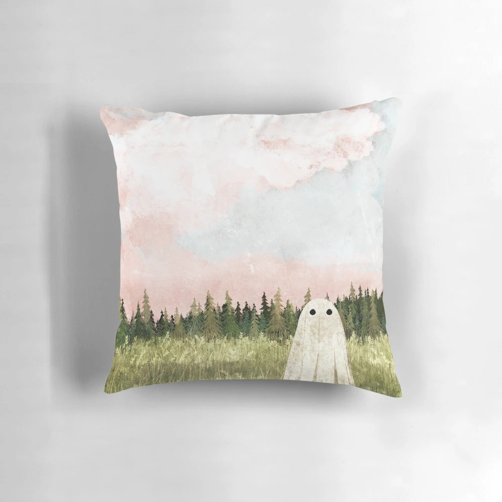 Pillow featuring a dreamy, cotton candy-colored sky with wispy clouds over a haunting spring meadow