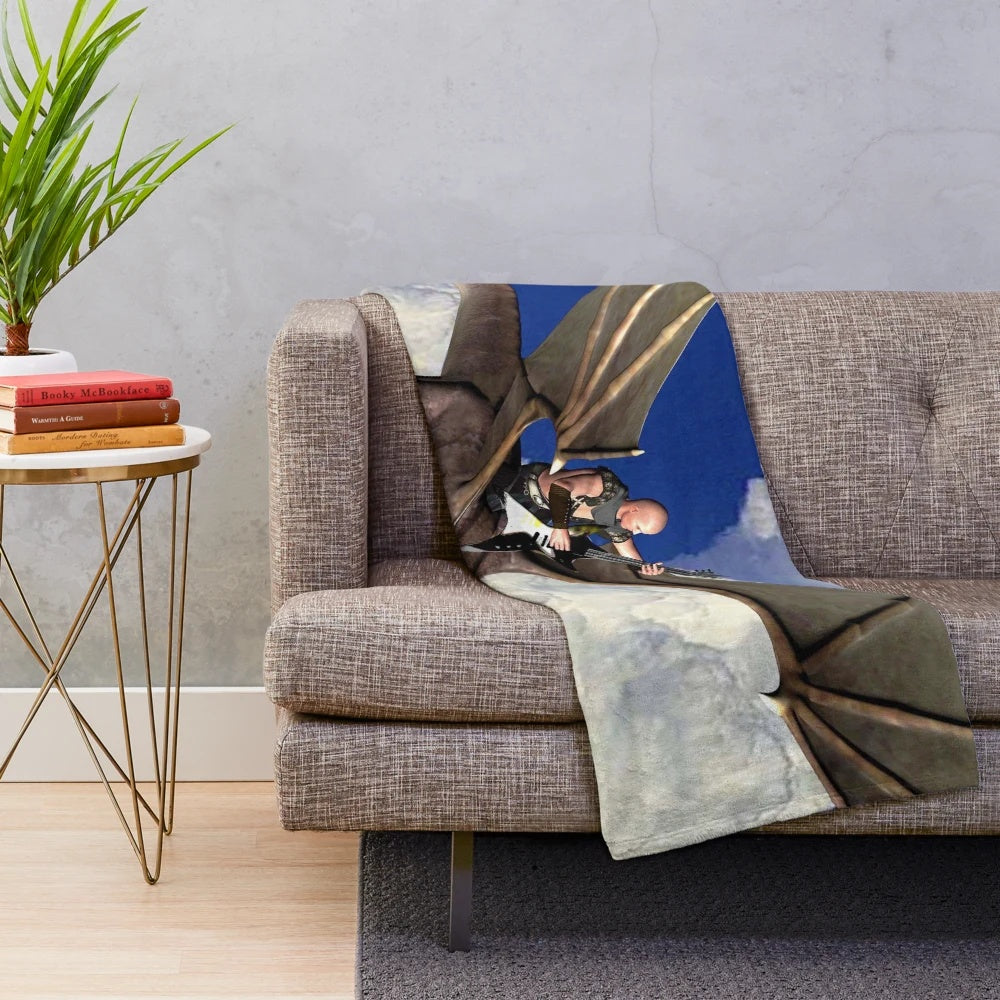 Plush blanket featuring a whimsical dragon soaring through cloudy skies