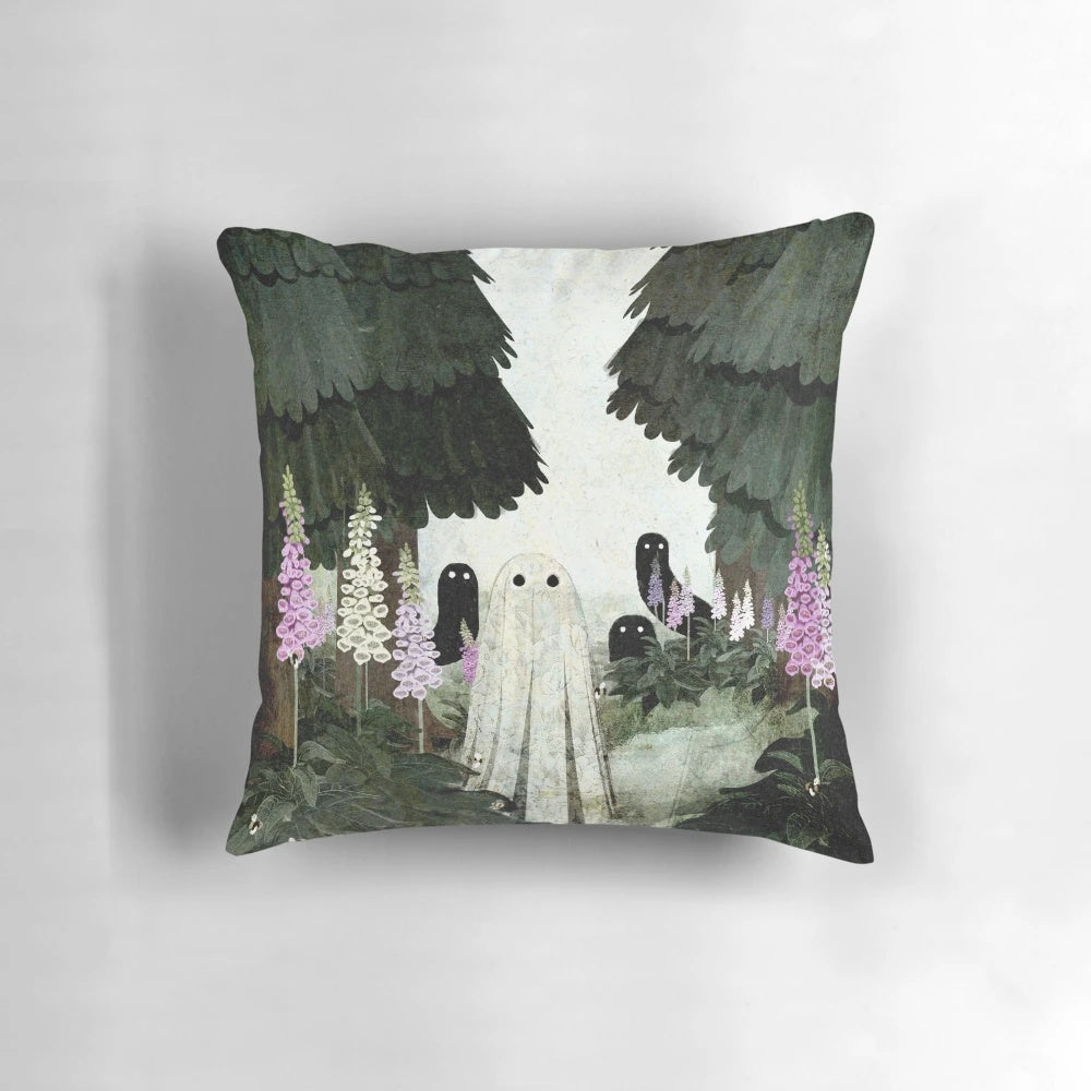 A decorative pillow featuring a ghostly, ethereal image of foxglove flowers blooming in a forested setting.