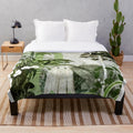 Plush blanket with ghostly greenhouse design, featuring nature elements and a whimsical, vintage-inspired style.