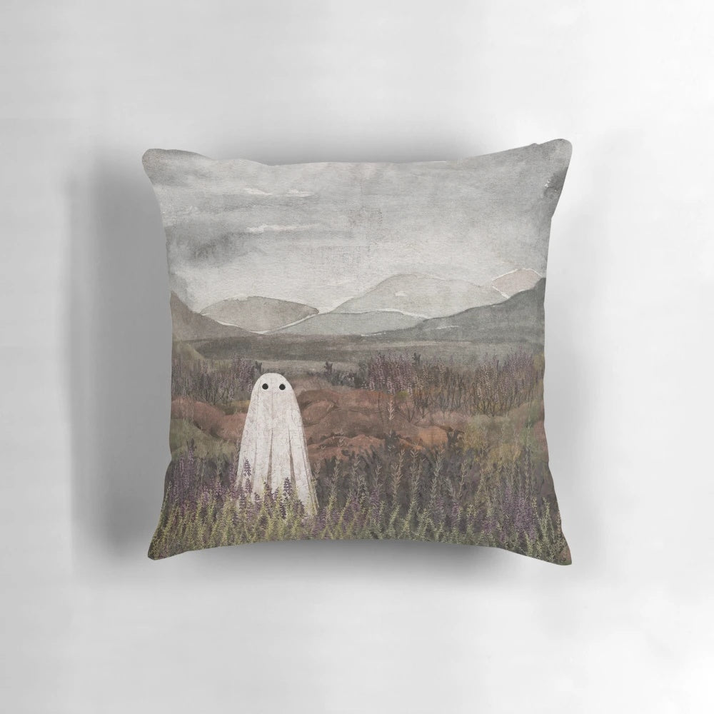 Soft, plush pillow featuring a watercolor painting of a misty, heather-covered Scottish mountain landscape with a ghostly, ethereal presence.