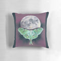 Soft pastel artwork of a luna moth on a background of a full moon, featured on a plush decorative pillow.