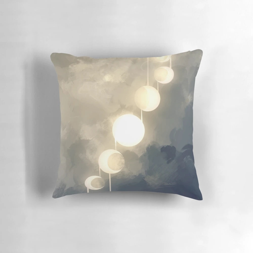 Pillow with a glowing, ethereal design featuring the phases of the moon