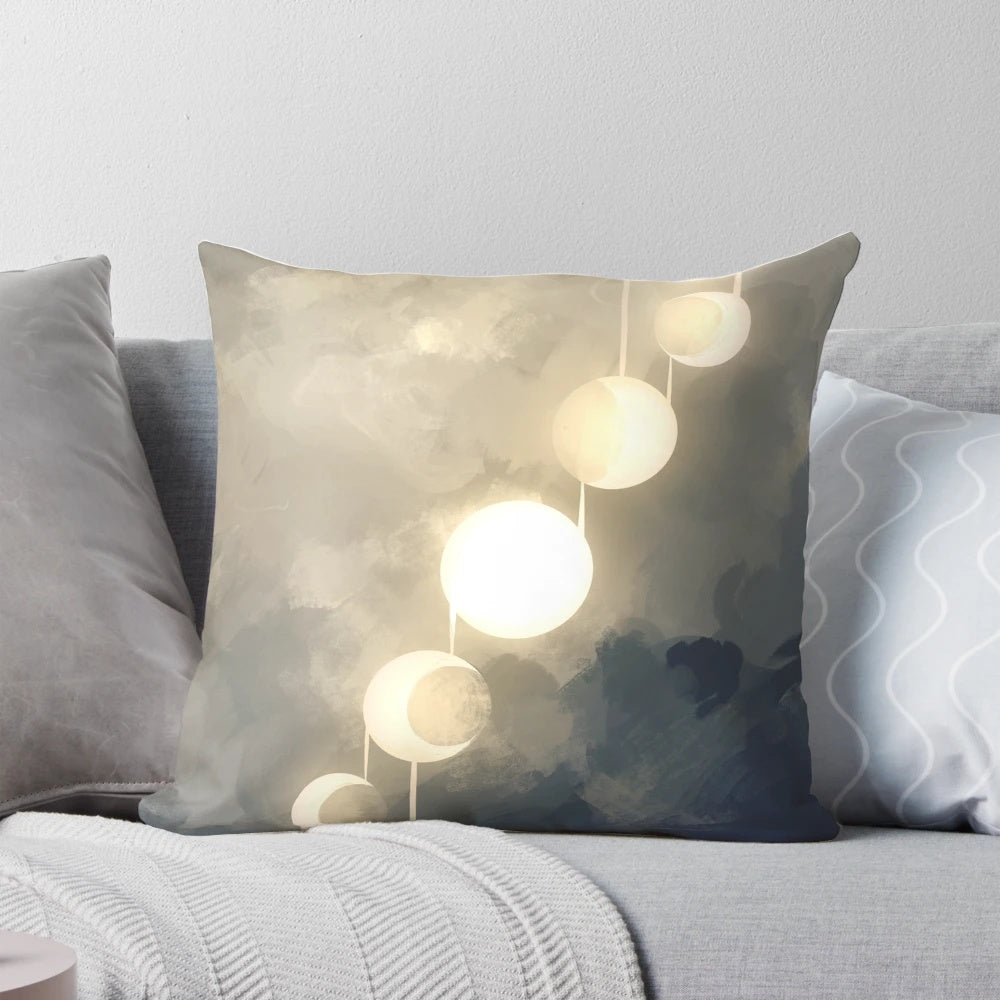 Pillow with a glowing, ethereal design featuring the phases of the moon