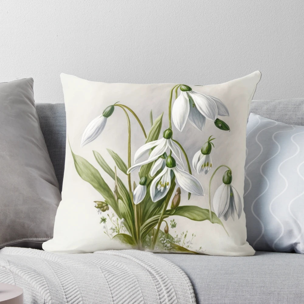 A decorative pillow featuring delicate white snowdrop flowers, a symbol of spring.
