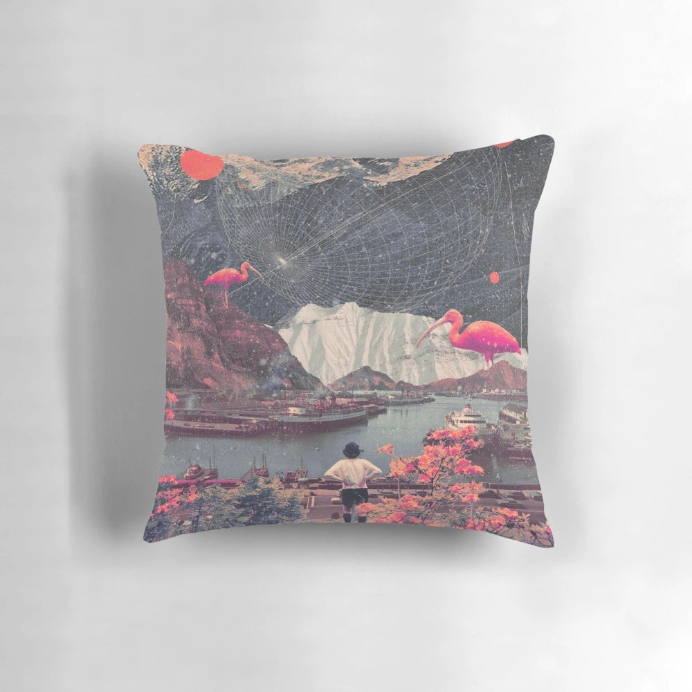 A vintage-inspired collage pillow featuring a solitary woman amidst a surreal landscape of mountains, flamingos, and floral elements.