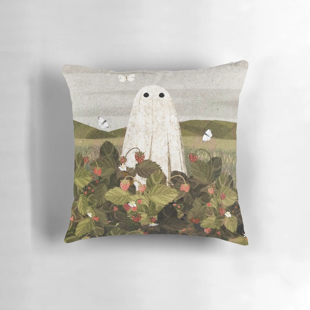 Soft, artistic pillow featuring a field of whimsical strawberries and ghostly apparitions