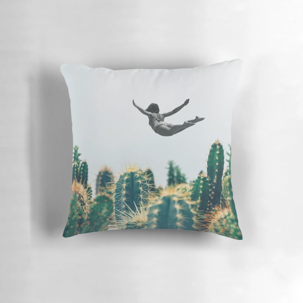 Surreal collage design featuring a floating cactus, vintage flowers, and a free-falling pillow.