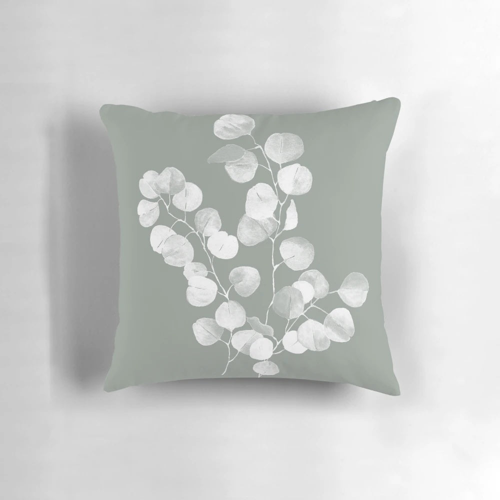 Eucalyptus and sage green botanical art design printed on a throw pillow.