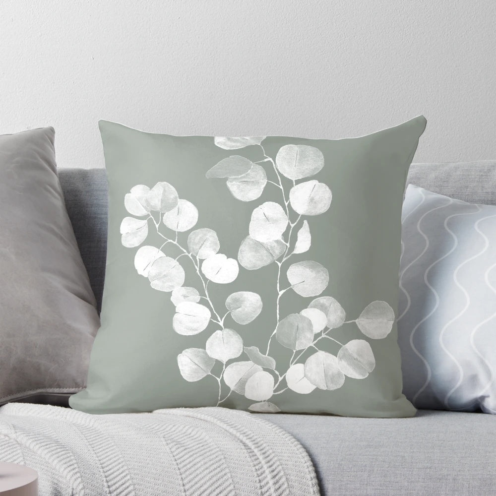 Eucalyptus and sage green botanical art design printed on a throw pillow.