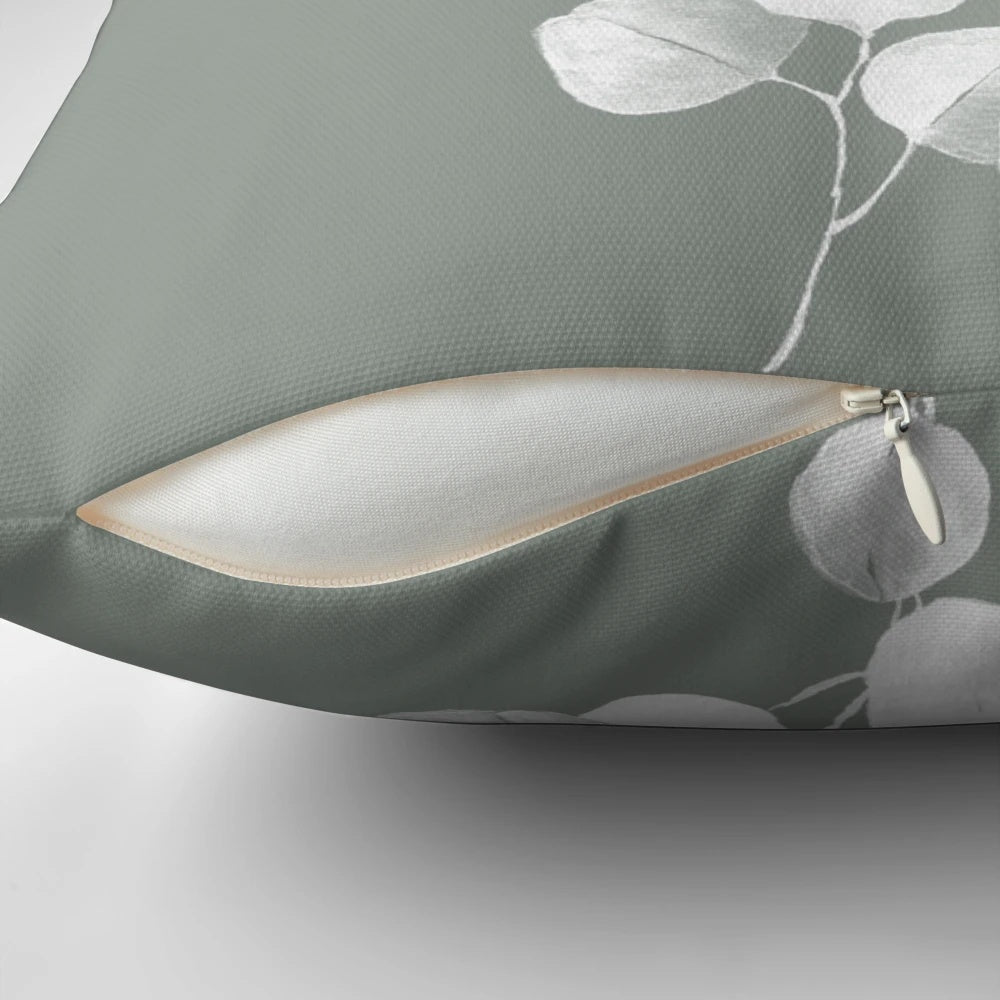 Eucalyptus and sage green botanical art design printed on a throw pillow.