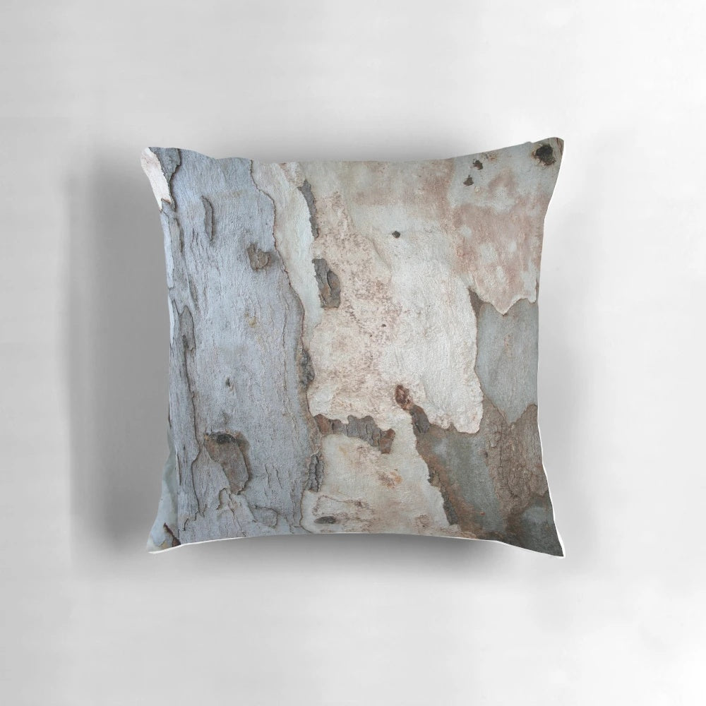 Close-up photograph of the textured bark of a eucalyptus tree, featured on a decorative throw pillow.