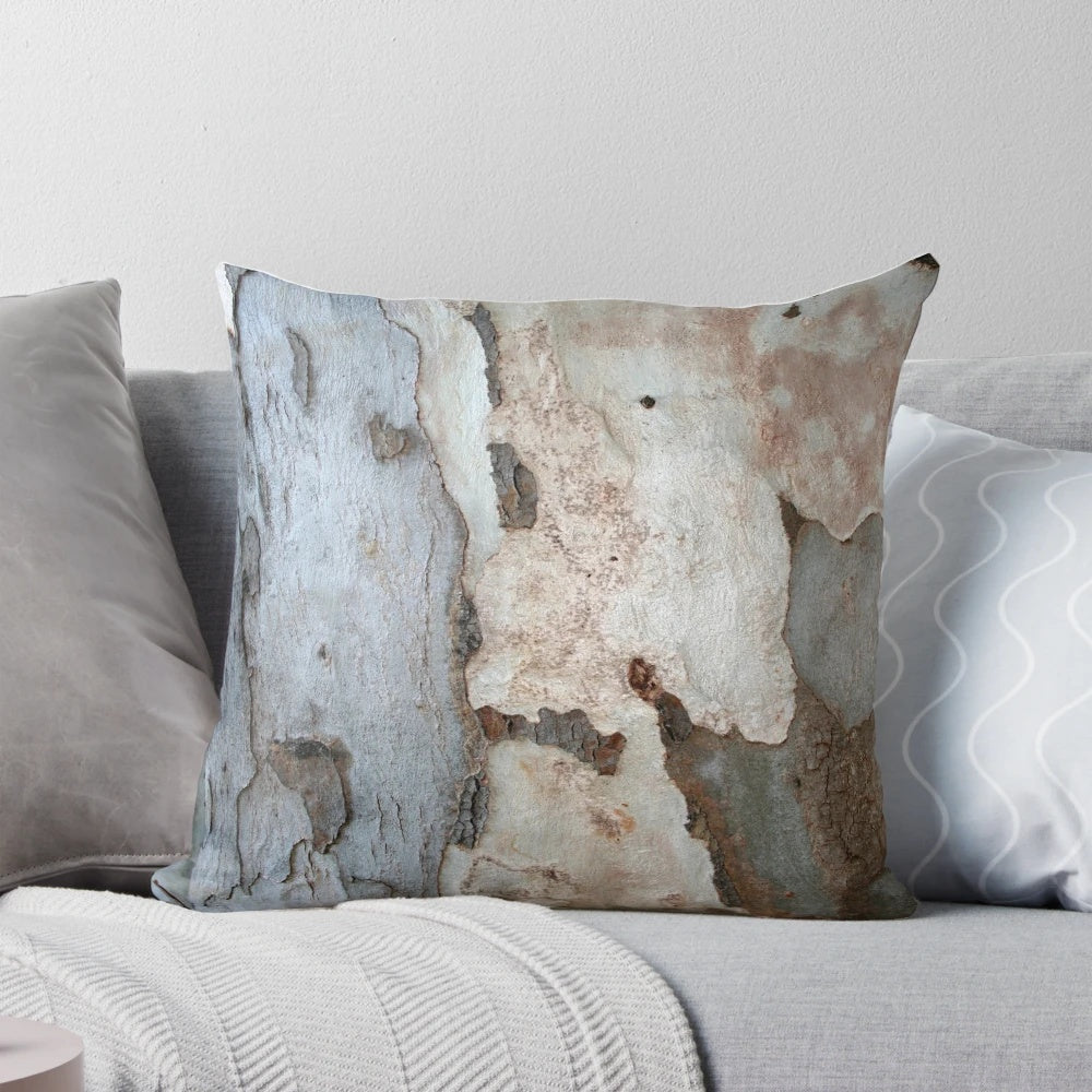 Close-up photograph of the textured bark of a eucalyptus tree, featured on a decorative throw pillow.