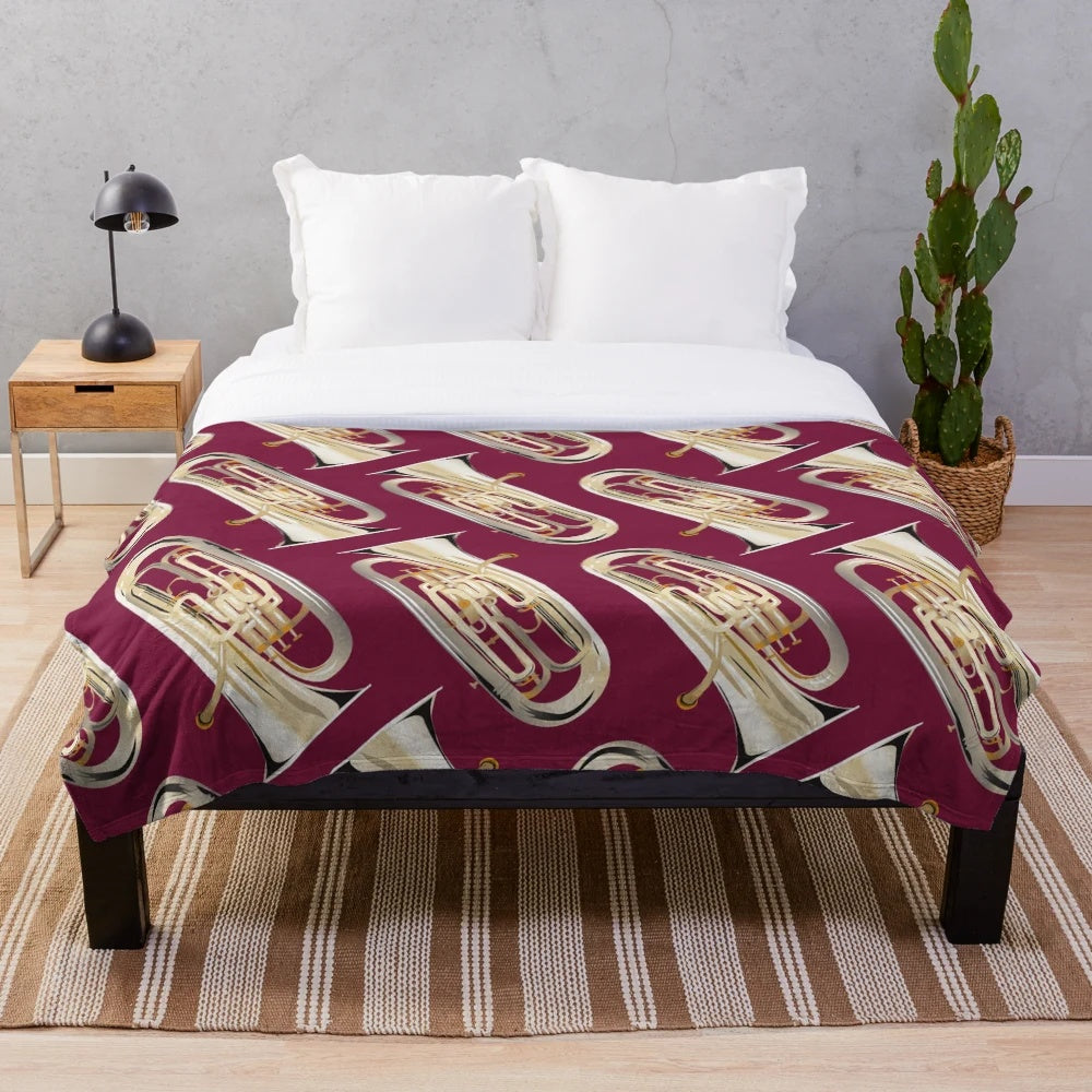 Dark red plush blanket with an euphonium design