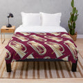 Dark red plush blanket with an euphonium design
