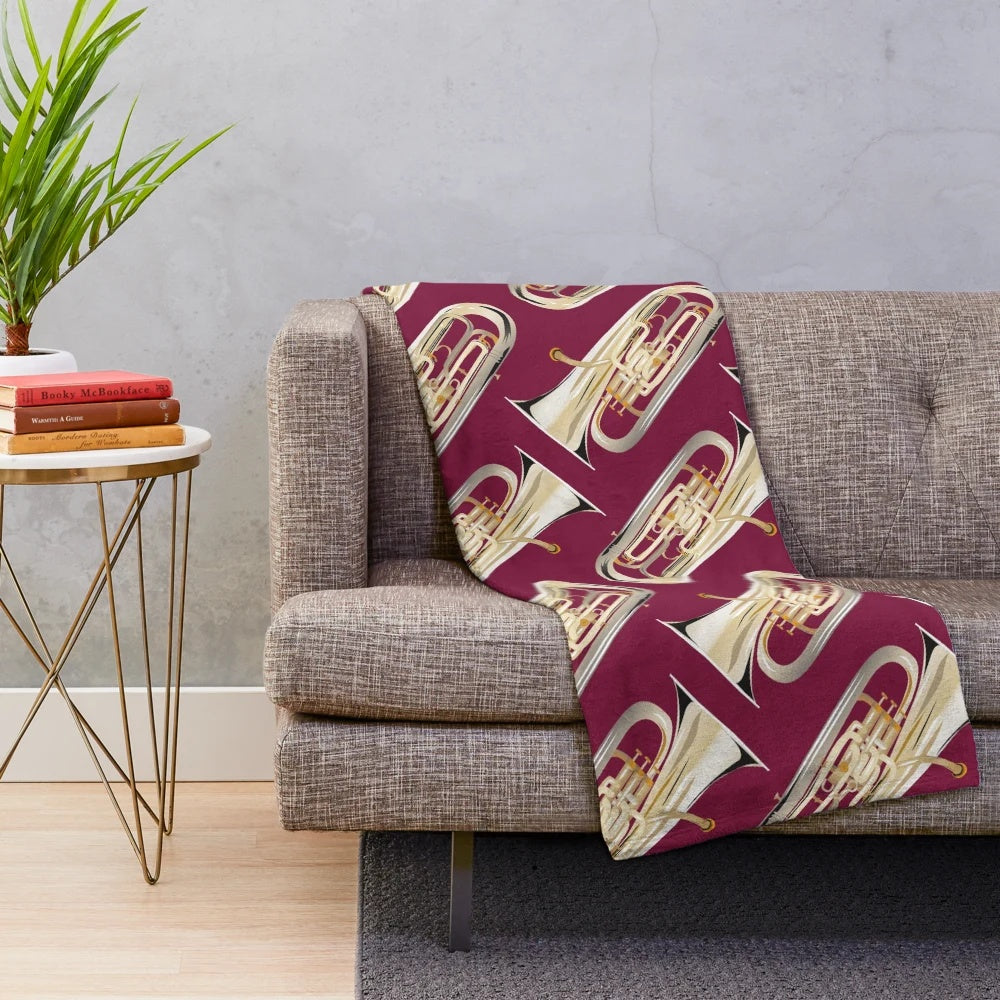 Dark red plush blanket with an euphonium design