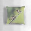 Photograph of a decorative pillow featuring a European goldfinch bird illustration by artist David Irwin.