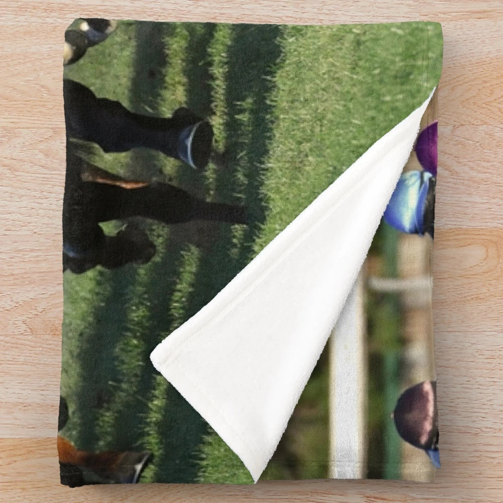 Plush blanket featuring a horse racing action scene